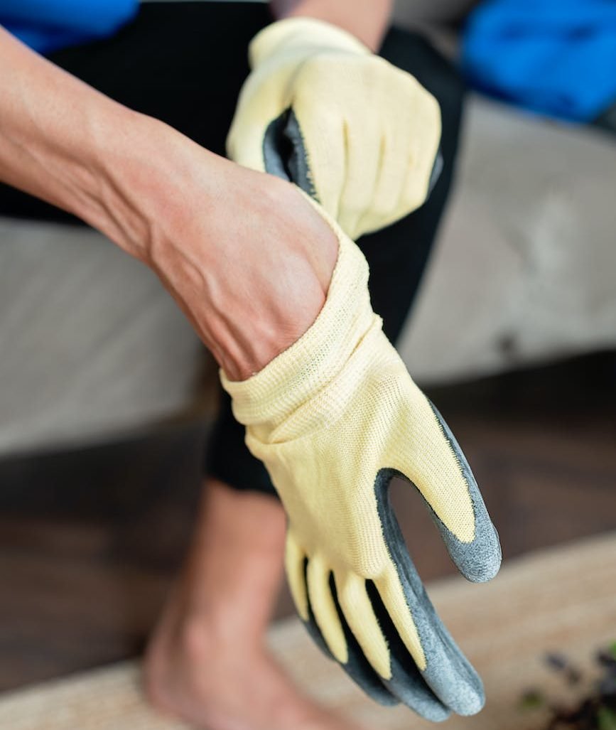 hands of a person wearing garden gloves